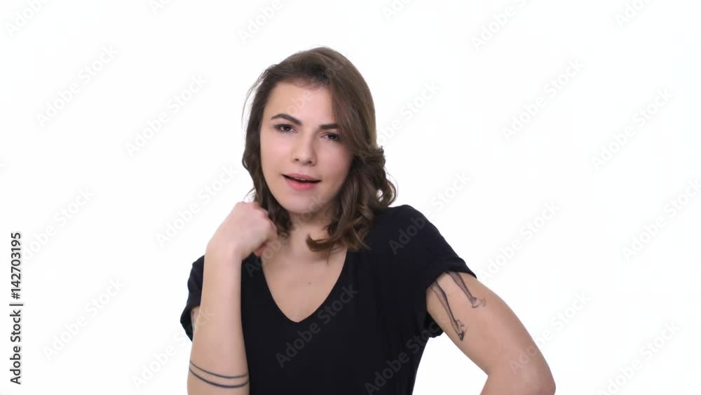 Attractive young woman flirting and doing beckon gesture with finger isolated Attractive young woman flirting and doing beckon gesture with finger isolated