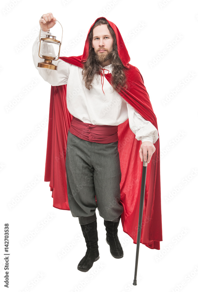 Medieval man in cape with cane and lamp isolated