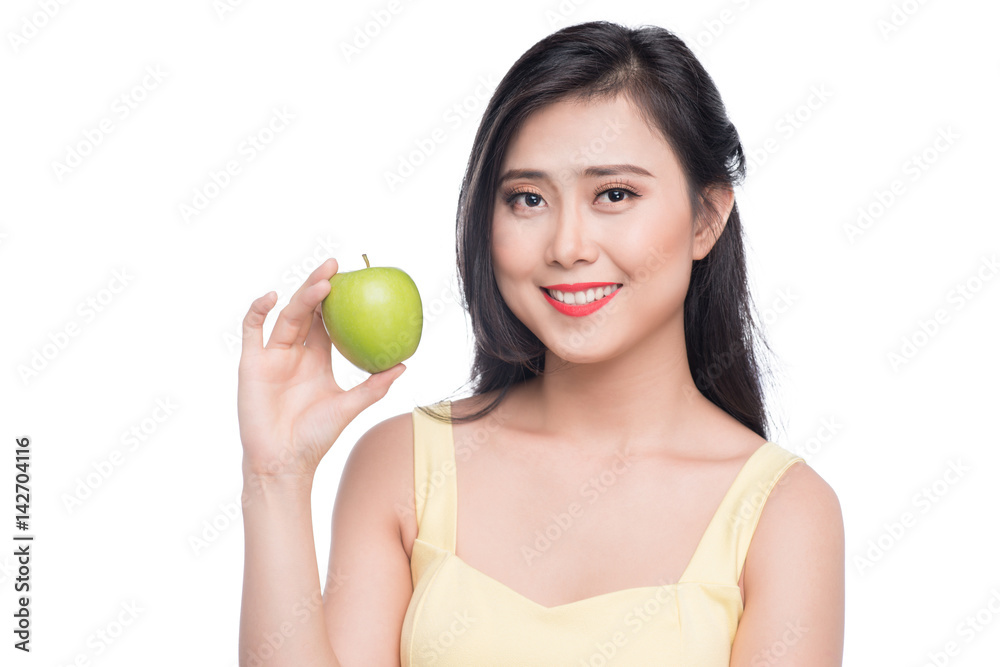 Pretty young asian woman holding fresh apple isolated on white background. Pretty young asian woman holding fresh apple isolated on white background.
