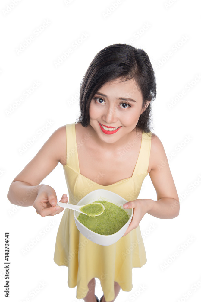 Portrait of asian woman eating/holding a plate of green vegetables soup Portrait of asian woman eating/holding a plate of green vegetables soup