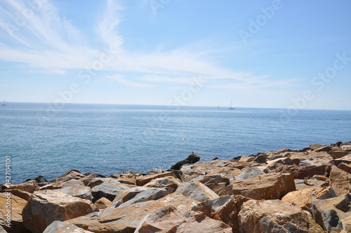 Yachts and boats sailing along the calm water of the Mediterranean Sea during the day