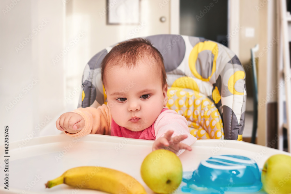 smiling baby eating food on kitchen smiling baby eating food on kitchen