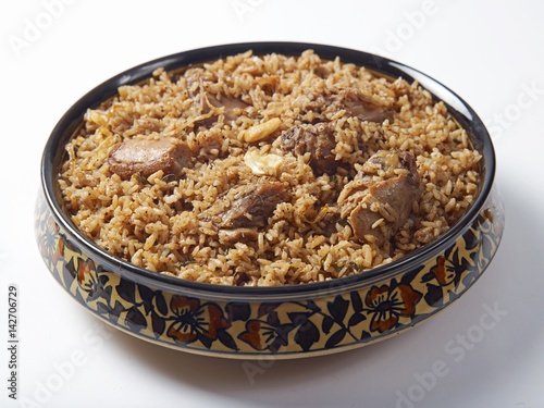 mutton biriyani served in a bowl on white background