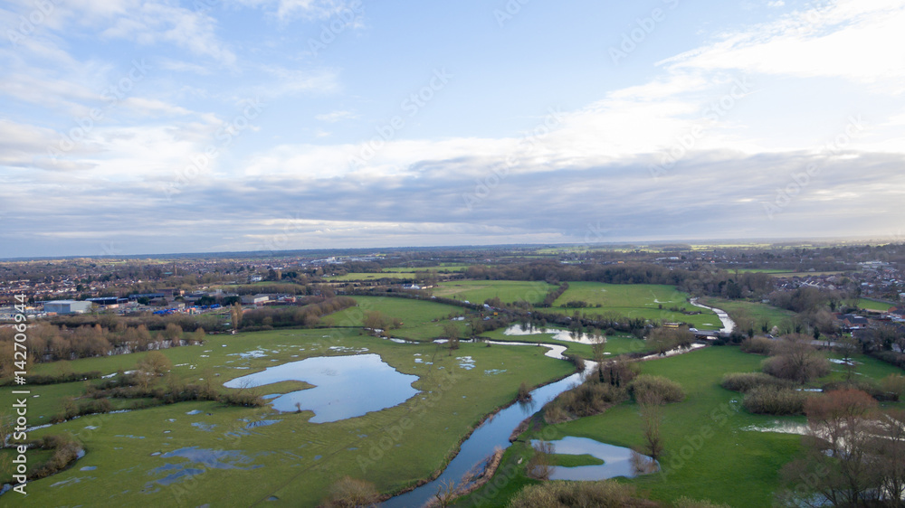 Aerial view of a lake and river area in the countryside late afternoon in the winter