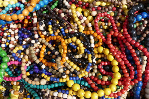 multicolored heap of decorative wooden necklaces