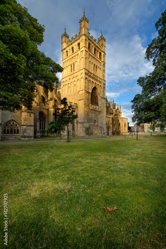 North tower of the cathedral in Exeter. It is illuminated by the low sun. Early morning. Devon. England
