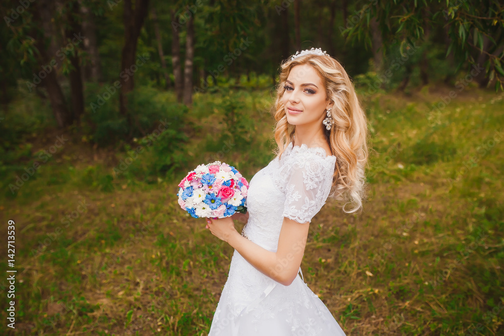 Beautiful bride outdoors in a forest. Beautiful bride outdoors in a forest.