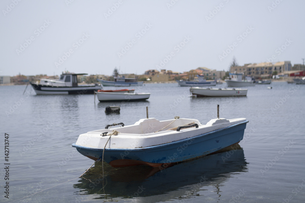 A little old boat docked  at the marina in Marzamemi village.