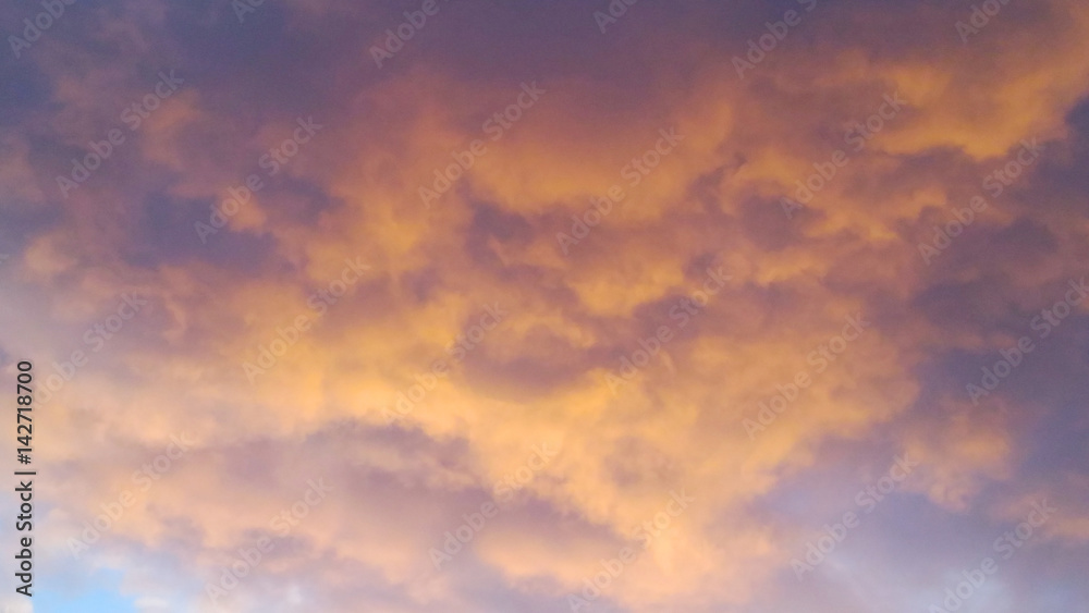scarlet sky with clouds during sunset