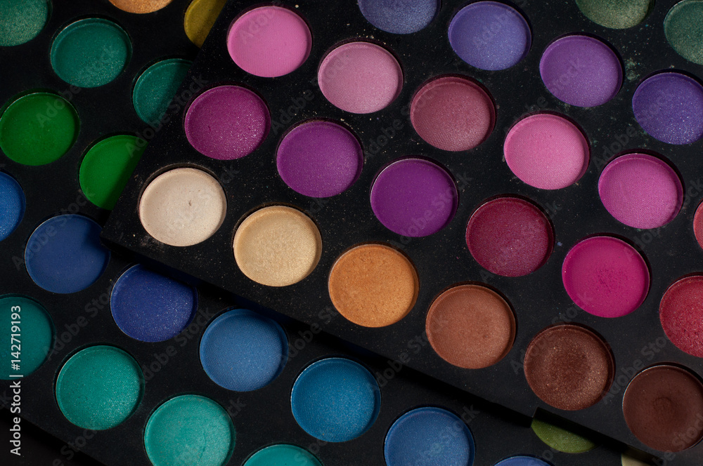 Palette of professional colorful eye shadows. Collection of multicolor eyeshadows. Makeup set background. Palette of professional colorful eye shadows. Collection of multicolor eyeshadows. Makeup set background.