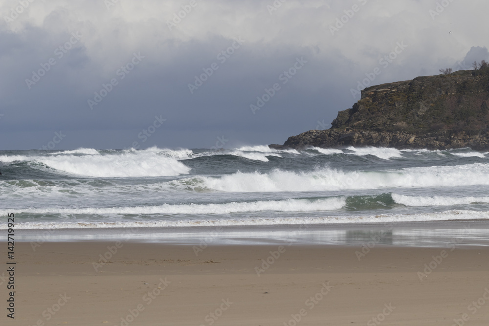 Cloudy day in a beach with strong swell Cloudy day in a beach with strong swell