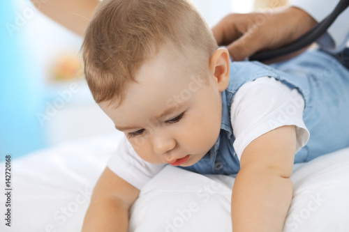 Little boy child with his mother at health exam at doctor's office.