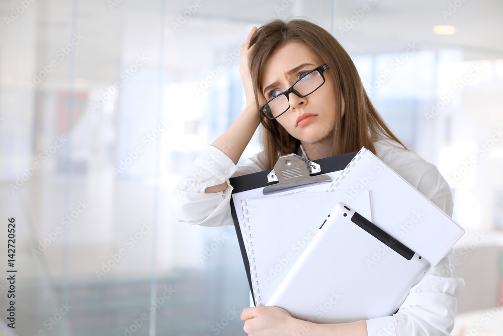 Tired business woman while standing in the office Tired business woman while standing in the office