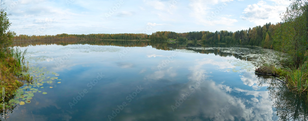 Fototapeta premium Panorama of Svetloyar Lake with forest along bank reflecting in calm water. Nizhegorodsky region, Russia 