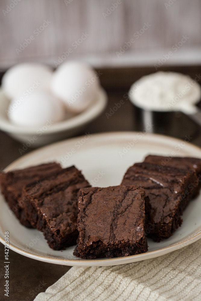 Brownies on a Plate With Eggs and Flour Brownies on a Plate With Eggs and Flour