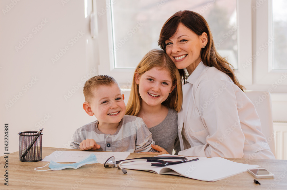 Female pediatritian with her young patients Female pediatritian with her young patients