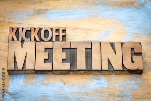 Kickoff meeting word abstract in wood type