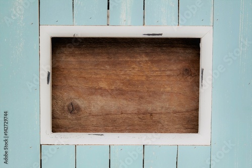 A photo of a wooden frame with the colors white, blue, and brown. To use as invitations, advertising, menu card, and other occasions. A clear image or background with plenty of text space. photo