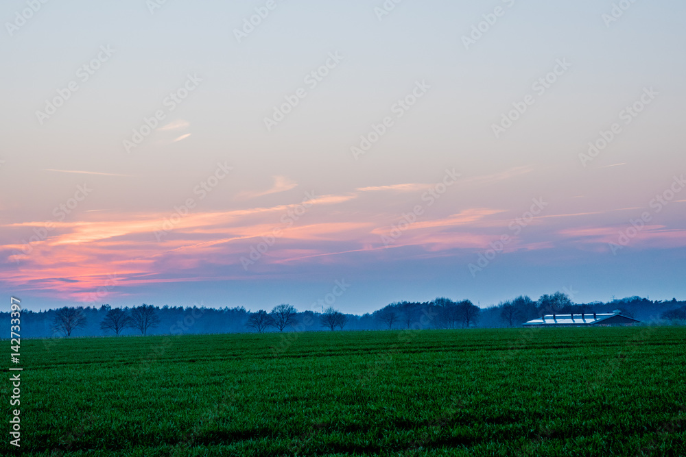 sunset in Europe Germany with a green field