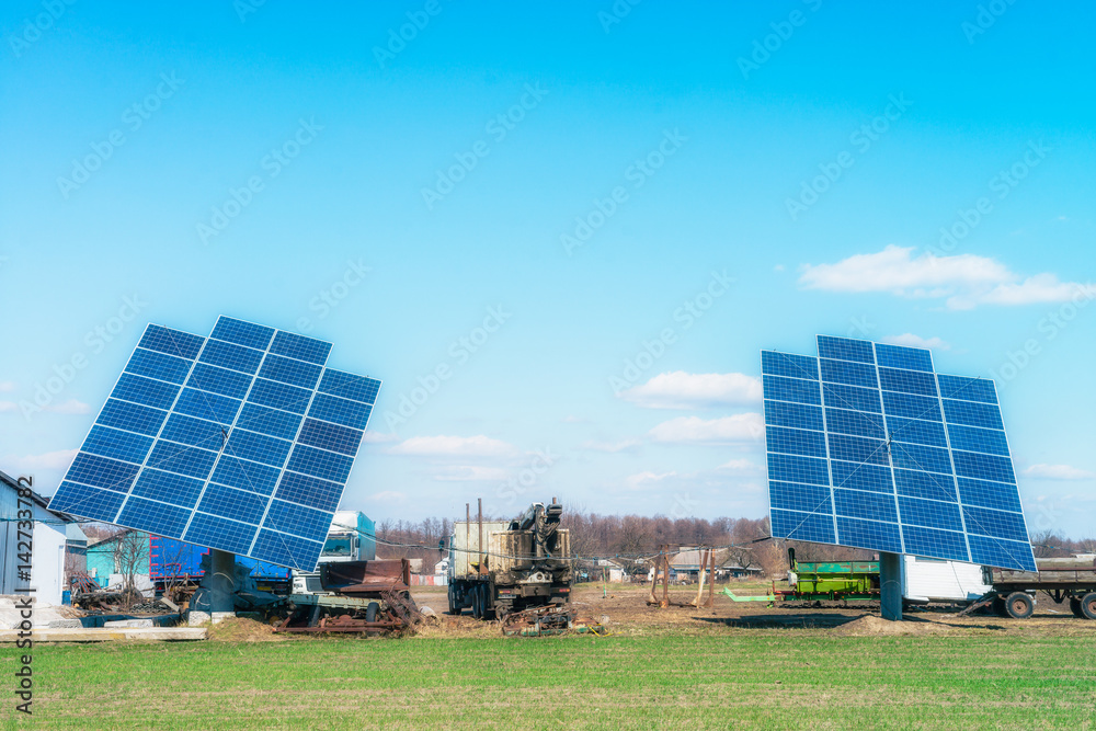 Solar panels on the green field in sunny weather. Vivid colorful image. Solar panels on the green field in sunny weather. Vivid colorful image.