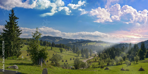 Sunrise over Carpathian Mountains at Scarisoara , Romania photo