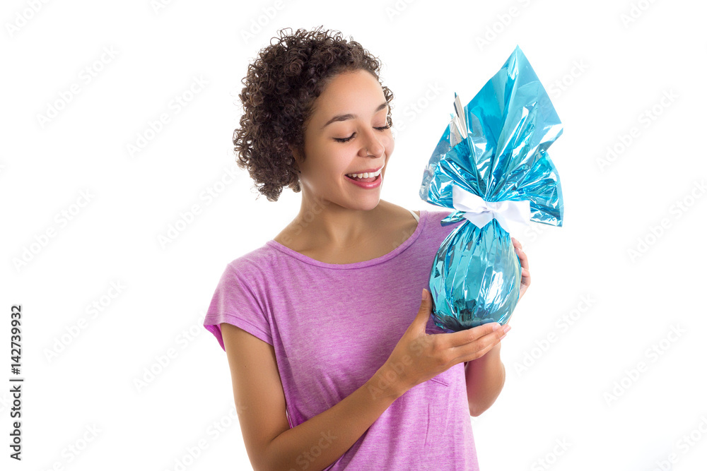 Woman presents Easter egg packed in blue paper. Woman presents Easter egg packed in blue paper.