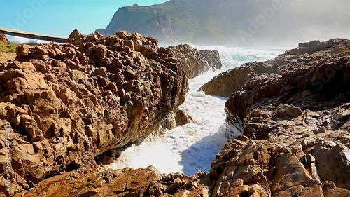 Stormy Sea water rushing in between rocks on the coast