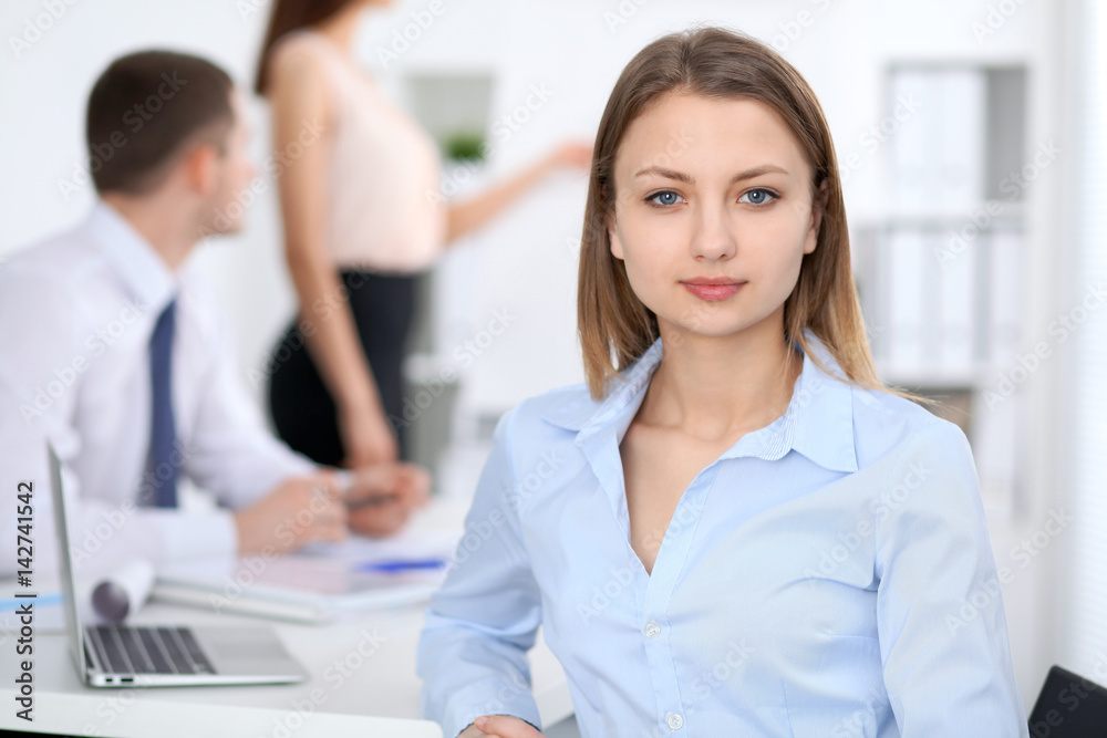 Portrait of a young business woman at meeting. Portrait of a young business woman at meeting.