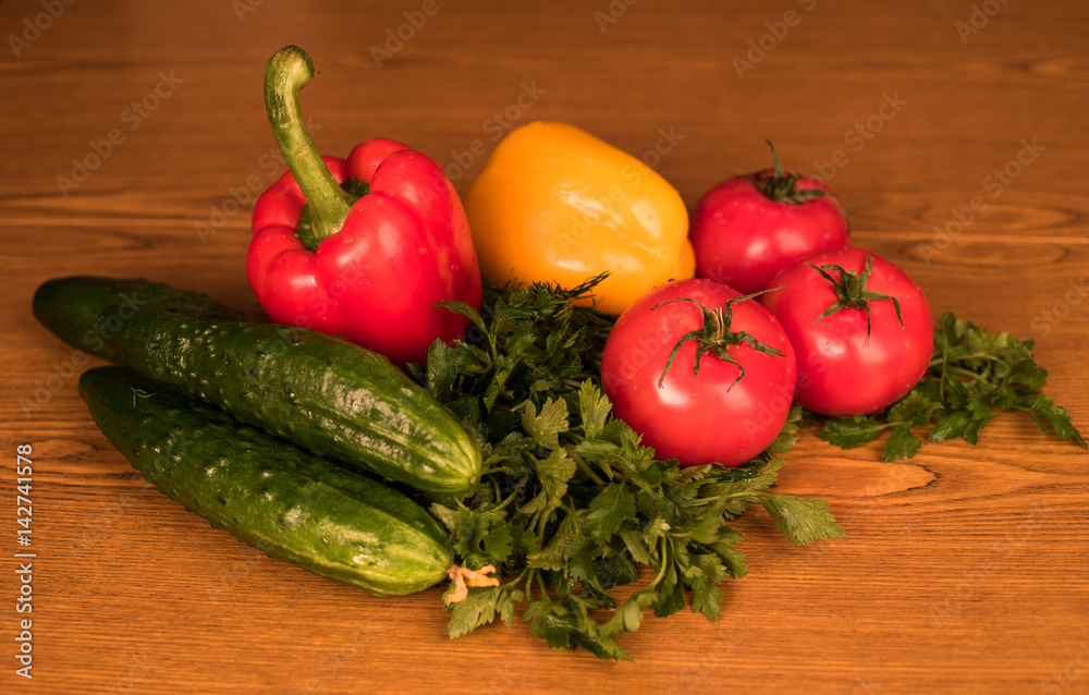 Ripe vegetables lie on the table. Mature and fresh vegetables lie on a wooden board. Appetizing vegetables for salad. Agricultural products Ripe vegetables lie on the table. Mature and fresh vegetables lie on a wooden board. Appetizing vegetables for salad. Agricultural products