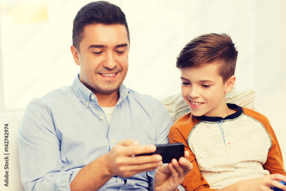 happy father and son with smartphone at home happy father and son with smartphone at home