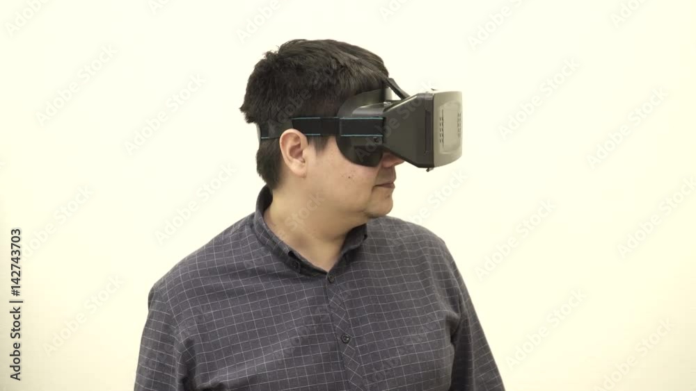 Young man looking in different sides in the virtual glasses Young man looking in different sides in the virtual glasses