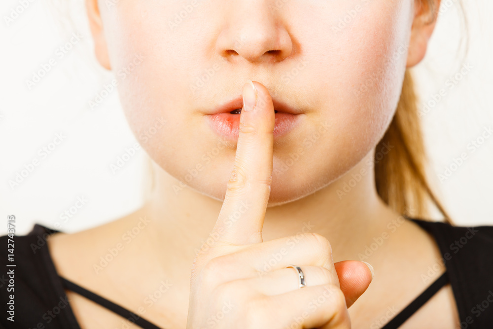 Naklejka premium Woman showing silence gesture with finger