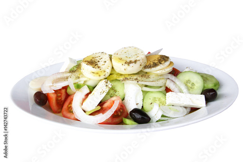 Healthy food - the Greek salad on a white plate close up
