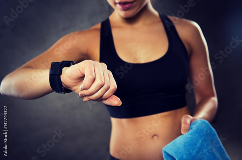 close up of woman with smartwatch and towel in gym © Syda Productions