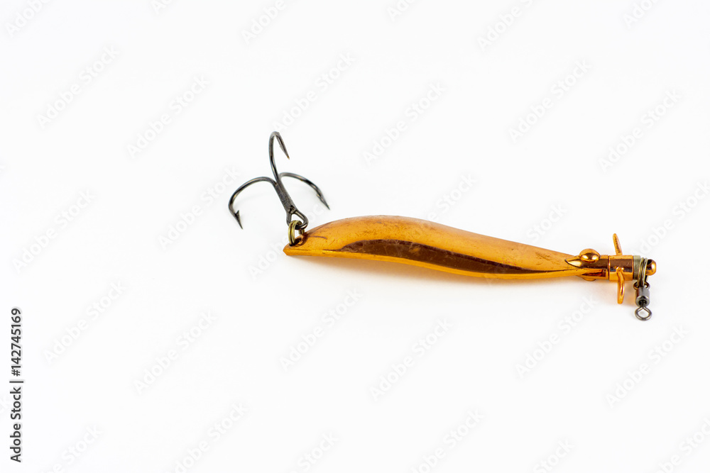 Exhibition of self-made fishing metal lures. Bait for fishing in the shape of a spoon with a hook on a white background. Exhibition of self-made fishing metal lures. Bait for fishing in the shape of a spoon with a hook on a white background.