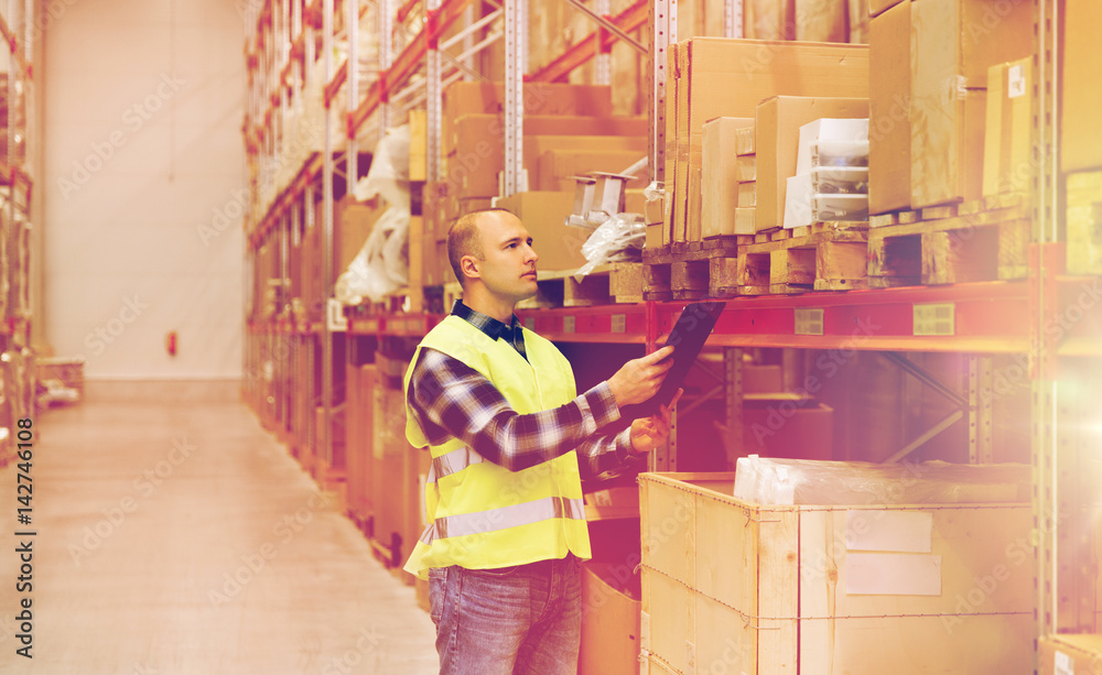 man with clipboard in safety vest at warehouse man with clipboard in safety vest at warehouse