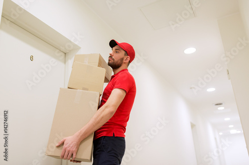 delivery man with parcel boxes at customer door