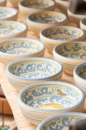 Closeup view of some decorated ceramic bowls in a workshop of Caltagirone, Sicily