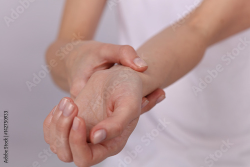 Woman hands checking heart rate pulse on wrist close up
