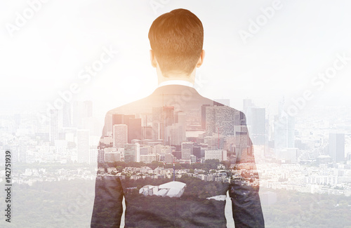 Rear view of businessman looking at city photo