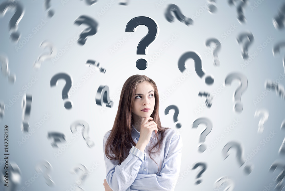 Pensive girl and many question marks Pensive girl and many question marks