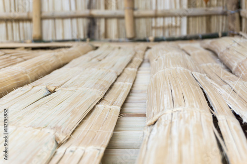 Nippa hut under construction, made from bamboo with a palm tree leaves roof top photo