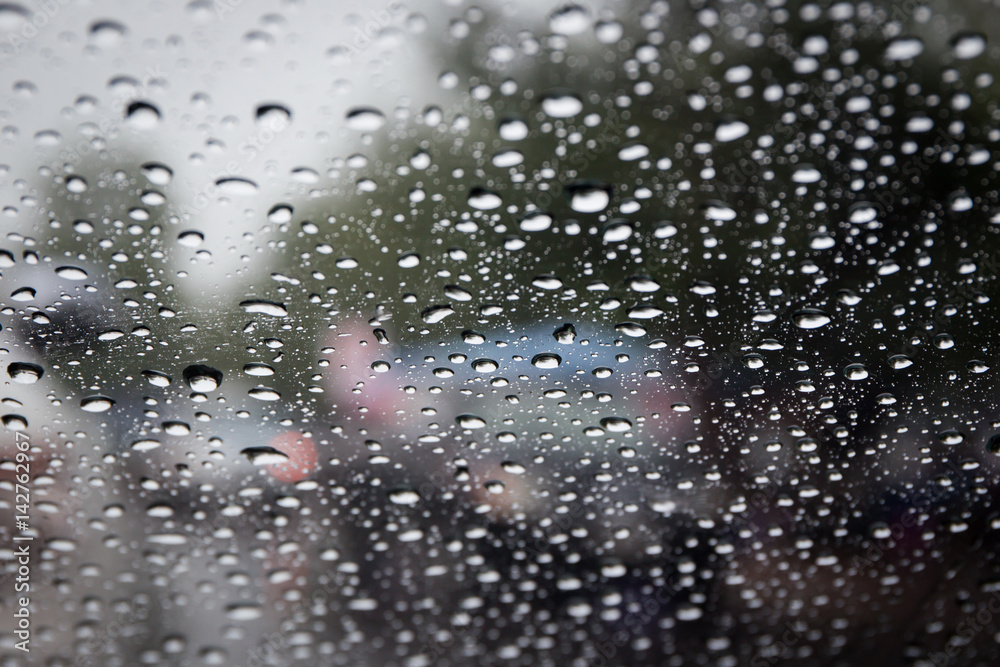 Rain drop on car glass close up background.
