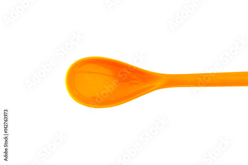 Orange plastic spoon