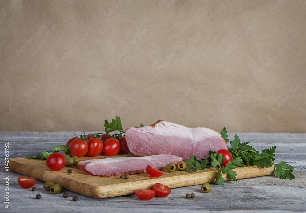 rustic background with delicious hum, parsley, tomatoes, onions, dill, olives and peppers on wooden cutting board