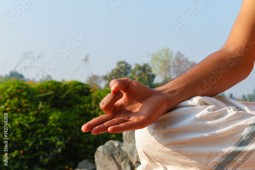 A hand showing a yoga mudra (hand gesture) known as gyan-mudra used in meditation.