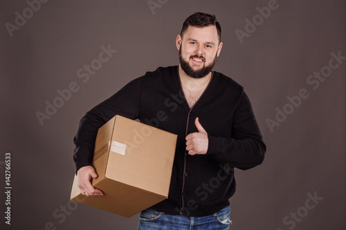 man holding pile of cardboard boxes in front