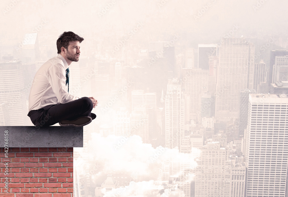 Office worker sitting on rooftop in city Office worker sitting on rooftop in city