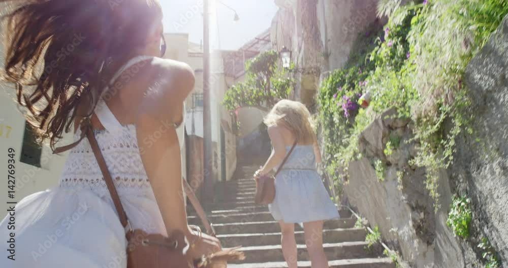 Happy Young Tourist Woman running up through street in Italian town smiling and laughing POV travel concept Amalfi Coast Positano Italy Rear view Happy Young Tourist Woman running up through street in Italian town smiling and laughing POV travel concept Amalfi Coast Positano Italy Rear view