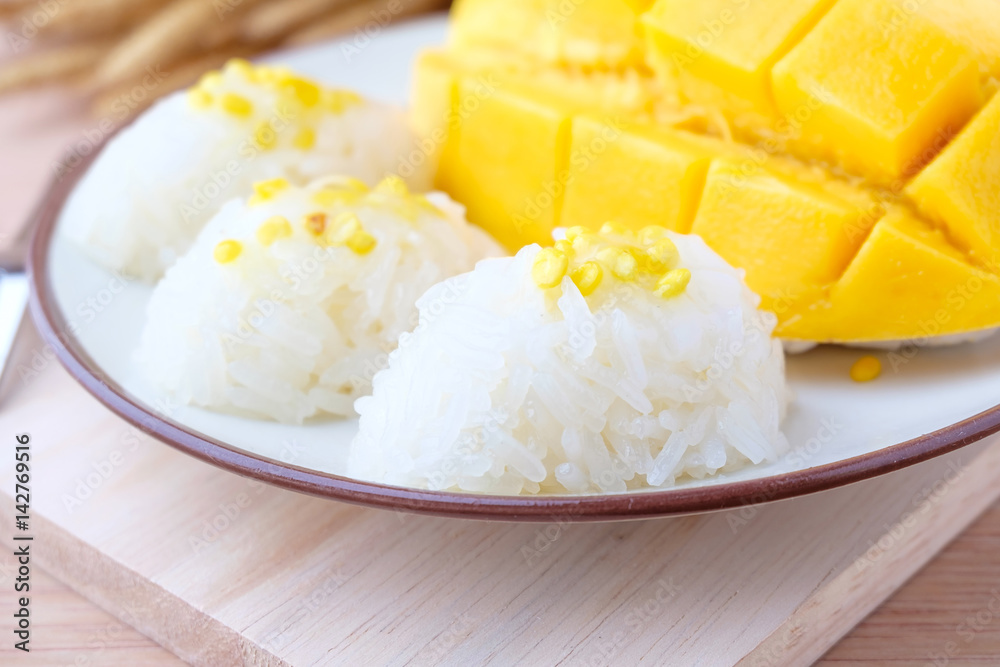 mango and sticky rice on wood background mango and sticky rice on wood background